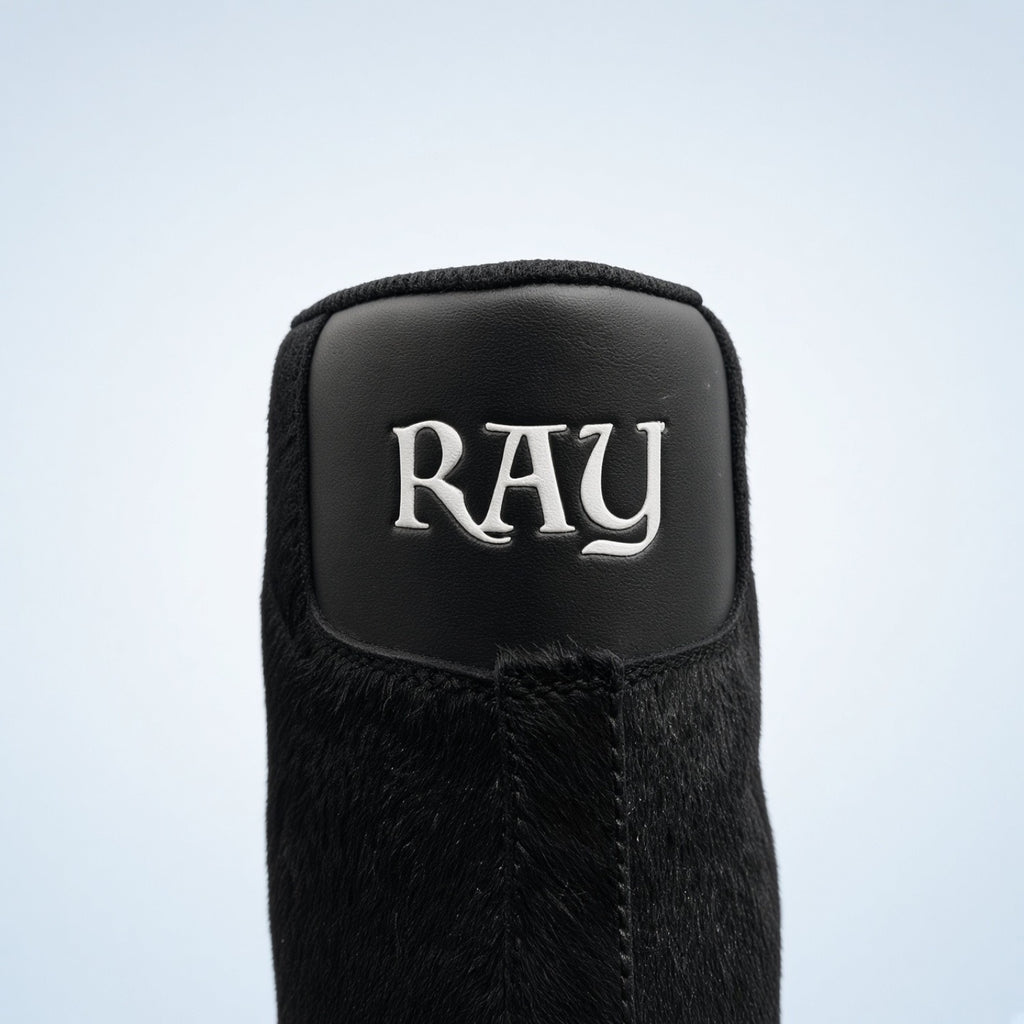 Close view of the black leather heel with raised silver RAY