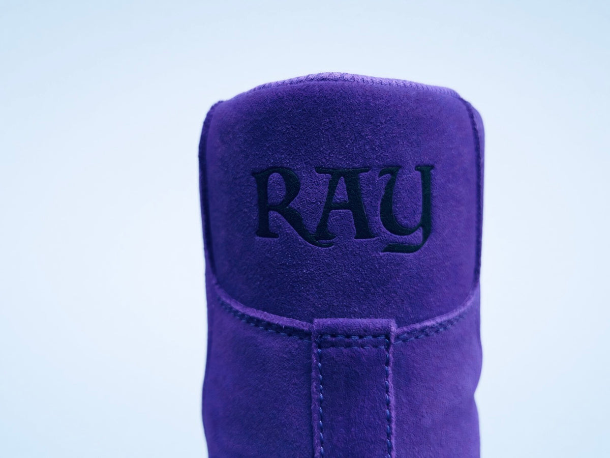 Close view of the purple suede heel with black embroidered RAY